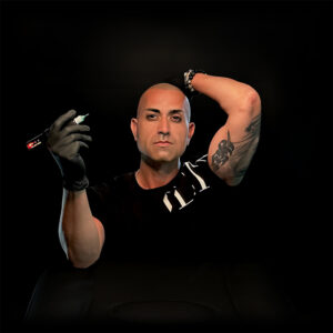 Alex Asher holding scalp micropigmentation machine